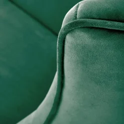 Poltrona a dondolo relax imbottita in velluto verde scuro Nanna